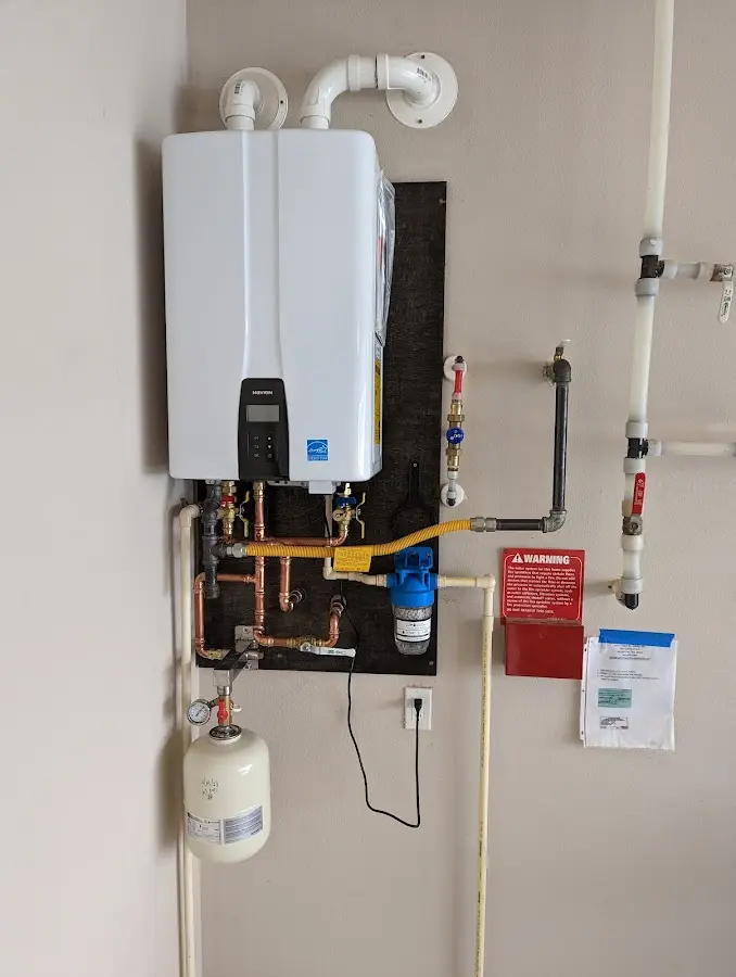 Professional plumber installing copper piping in a Danville home